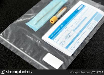 medicine, healthcare and pandemic concept - beaker with test, cotton swab and medical report in plastic zipper bag. beaker with test, cotton swab and medical report