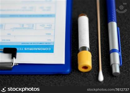 medicine, healthcare and pandemic concept - medical report on clipboard, beaker with test, cotton swab and pen on table. medical report, test tube, cotton swab and pen