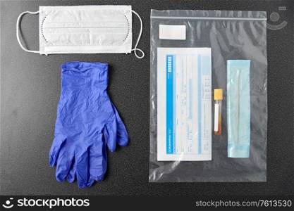 medicine, healthcare and pandemic concept - test tube, cotton swab with medical report in plastic zipper bag and protective gloves with medical mask on table. test tube, medical report, gloves and mask