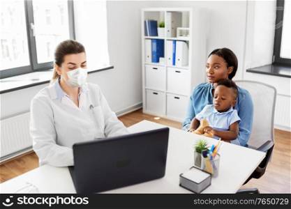 medicine, healthcare and pediatry concept - african american mother with baby son and caucasian doctor wearing protective medical mask for protection from virus disease with laptop computer at clinic. mother, baby and doctor in mask with laptop