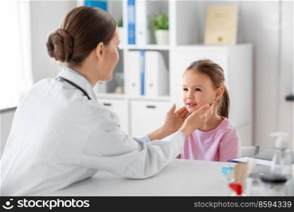 medicine, healthcare and pediatry concept - female doctor or pediatrician checking little girl patient’s tonsils on medical exam at clinic. doctor checking girl patient’s tonsils at clinic
