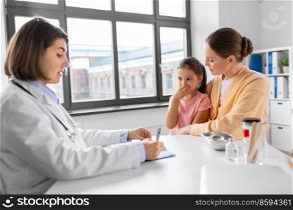 medicine, healthcare and pediatry concept - mother with little coughing daughter and doctor with clipboard at clinic. mother, coughing daughter and doctor at clinic