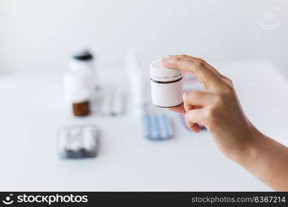 medicine, healthcare and people concept - close up of doctor hand with showing jar with drug. close up of doctor hand with medicines