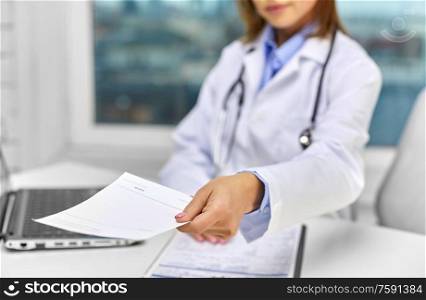 medicine, healthcare and people concept - close up of doctor with prescription at hospital. close up of doctor with prescription at hospital