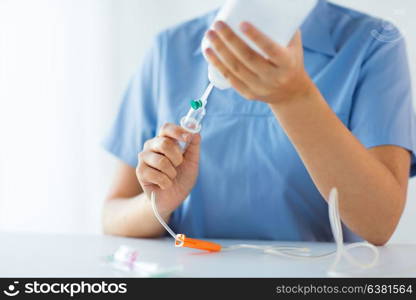 medicine, healthcare and people concept - close up of nurse preparing drop counter. close up of nurse preparing drop counter