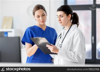 medicine, healthcare and people concept - doctor and nurse with clipboard at hospital. doctor and nurse with clipboard at hospital