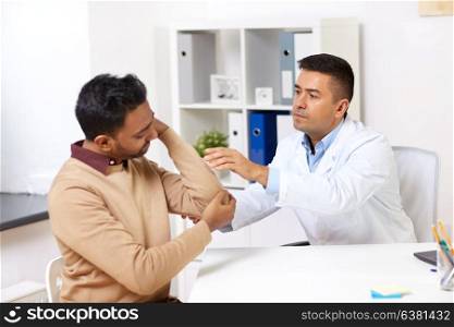 medicine, healthcare and people concept - doctor and patient with arm injury at hospital. doctor and patient with arm injury at hospital
