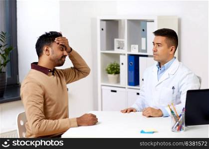 medicine, healthcare and people concept - doctor and patient with headache at hospital. doctor and patient with headache at hospital
