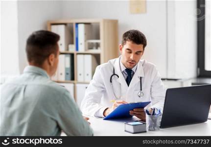 medicine, healthcare and people concept - doctor with clipboard and male patient at medical office in hospital. doctor with clipboard and male patient at hospital