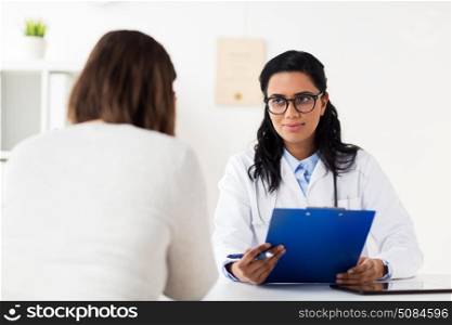 medicine, healthcare and people concept - doctor with clipboard and woman patient at hospital. doctor with clipboard and woman at hospital. doctor with clipboard and woman at hospital