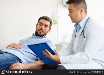 medicine, healthcare and people concept - doctor with clipboard and young male patient having health problem meeting at hospital. doctor and man with health problem at hospital