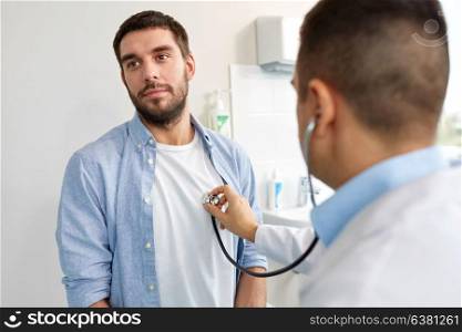 medicine, healthcare and people concept - doctor with stethoscope checking patient heart beat or breath at hospital. doctor with stethoscope and patient at hospital