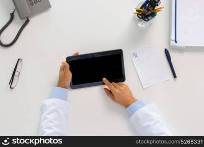 medicine, healthcare and people concept - doctor with tablet pc computer and prescription sitting at table in clinic. doctor with tablet pc and prescription at clinic