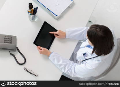 medicine, healthcare and people concept - doctor with tablet pc computer at table in clinic. doctor with tablet pc at clinic