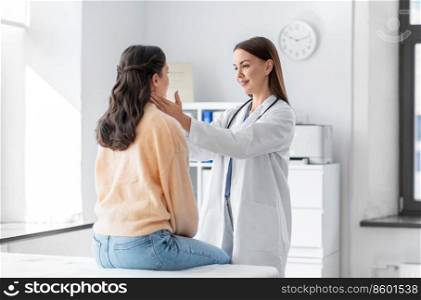 medicine, healthcare and people concept - female doctor checking lymph nodes of woman patient at hospital. doctor checking lymph nodes of woman at hospital