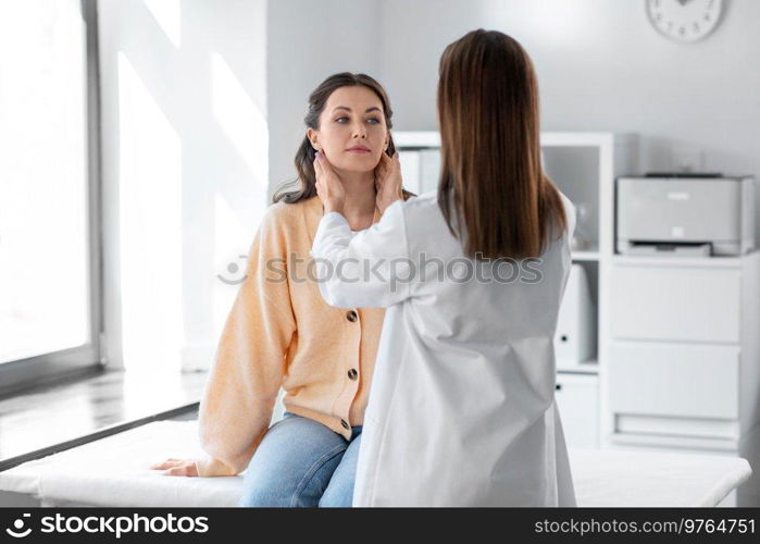 medicine, healthcare and people concept - female doctor checking lymph nodes of woman patient at hospital. doctor checking lymph nodes of woman at hospital