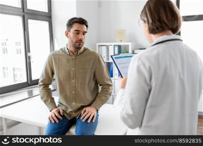 medicine, healthcare and people concept - female doctor with clipboard and male patient having health problem at hospital. doctor and man with health problem at hospital