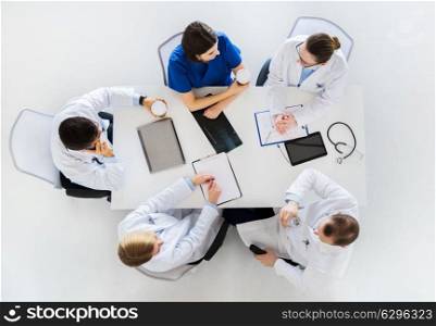 medicine, healthcare and people concept - group of doctors having coffee break at hospital. group of doctors having coffee break at hospital