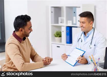 medicine, healthcare and people concept - happy doctor with cardiogram and young male patient meeting at hospital. happy doctor and male patient meeting at hospital
