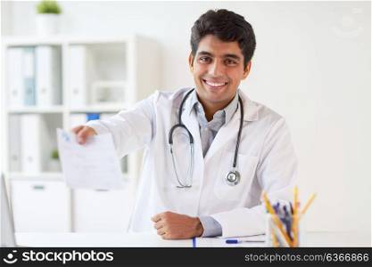 medicine, healthcare and people concept - happy male doctor with stethoscope and prescription at clinic. happy doctor with prescription at clinic
