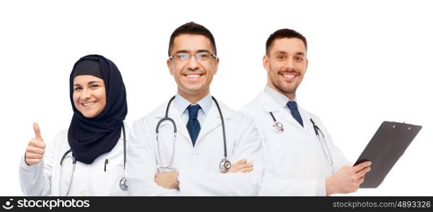 medicine, healthcare and people concept - happy smiling doctors in white coats with stethoscopes and clipboard showing thumbs up