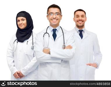 medicine, healthcare and people concept - happy smiling doctors in white coats with stethoscopes