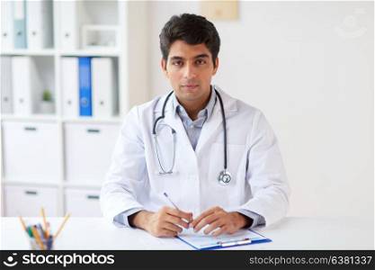 medicine, healthcare and people concept - male doctor with stethoscope and clipboard at clinic. doctor with stethoscope and clipboard at clinic