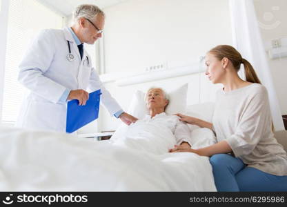 medicine, healthcare and people concept - senior woman patient with daughter and doctor with clipboard at hospital ward. senior woman and doctor with clipboard at hospital