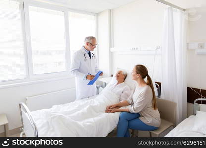 medicine, healthcare and people concept - senior woman patient with daughter and doctor with clipboard at hospital ward. senior woman and doctor with clipboard at hospital