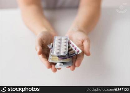 medicine, healthcare and people concept - woman hands holding packs of pills. woman hands holding packs of pills