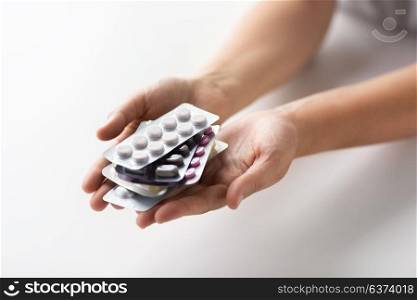medicine, healthcare and people concept - woman hands holding packs of pills. woman hands holding packs of pills
