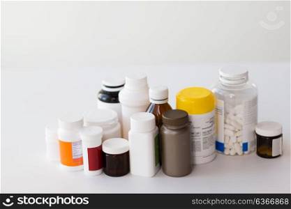 medicine, healthcare and pharmacy concept - jars of different drugs. jars of different medicines