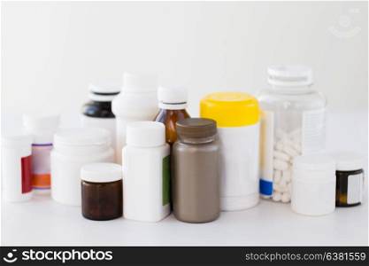 medicine, healthcare and pharmacy concept - jars of different drugs. jars of different medicines
