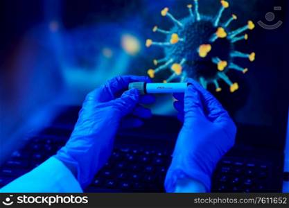 medicine, healthcare and science concept - close up of hand in protective medical glove holding beaker with virus positive blood test over coronavirus on laptop computer screen at laboratory. hand holding beaker with coronavirus blood test