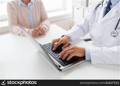 medicine, healthcare and technology concept - close up of doctor with laptop computer and senior woman at hospital. senior woman and doctor with laptop at hospital