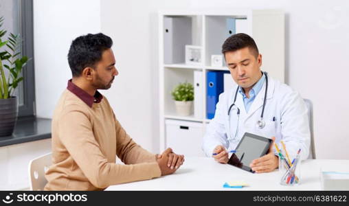 medicine, healthcare and technology concept - doctor with tablet pc computer and male patient talking at hospital. doctor with tablet pc and male patient at hospital