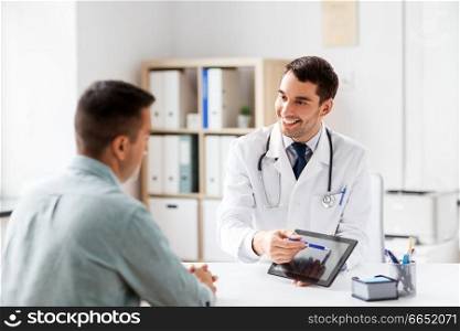 medicine, healthcare and technology concept - doctor with tablet pc computer and male patient talking at medical office in hospital. doctor with tablet computer and patient at clinic