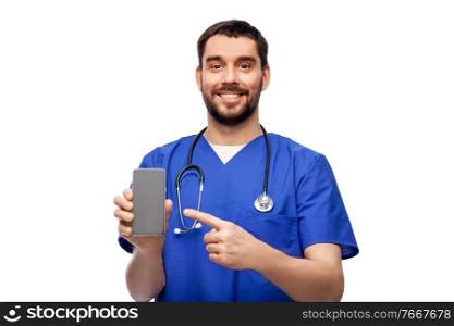 medicine, healthcare and technology concept - happy smiling doctor or male nurse in blue uniform with smartphone and stethoscope over white background. smiling doctor or male nurse with smartphone