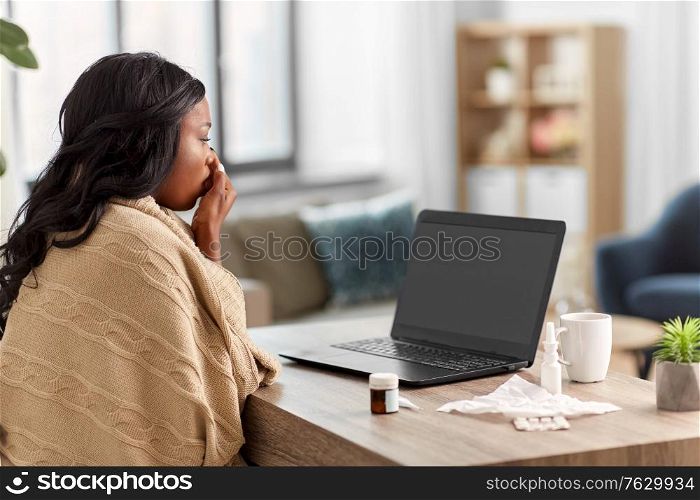 medicine, healthcare and technology concept - sick young african american woman having video call or online consultation on laptop computer at home. sick woman having video call on laptop at home