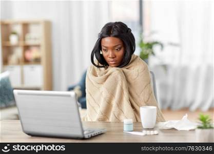 medicine, healthcare and technology concept - sick young african american woman having video call or online consultation on laptop computer at home. sick woman having video call on laptop at home