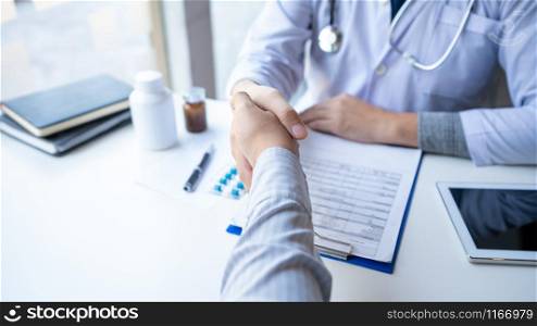 Medicine healthcare and trust concept, doctor shaking hands with patient colleague after talking about medical examination results