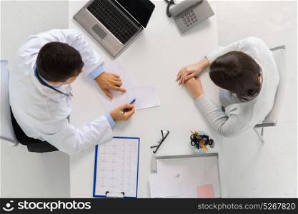 medicine, healthcare, cardiology and people concept - doctor with prescription and young patient woman meeting at hospital. doctor with prescription and patient at hospital