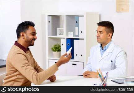 medicine, healthcare, medication and people concept - doctor and happy patient with nasal spray at hospital. doctor and patient with nasal spray at hospital