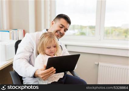 medicine, healthcare, pediatry and people concept - happy doctor or pediatrician holding little girl patient with tablet pc computer in medical office at clinic. doctor and little girl with tablet pc at clinic