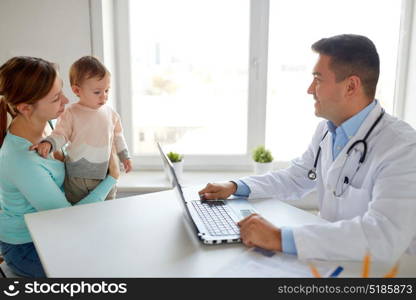 medicine, healthcare, pediatry and people concept - happy woman with baby and doctor with laptop computer at clinic. woman with baby and doctor with laptop at clinic