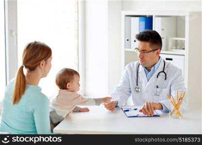 medicine, healthcare, pediatry and people concept - woman with baby and doctor at clinic. woman with baby and doctor at clinic