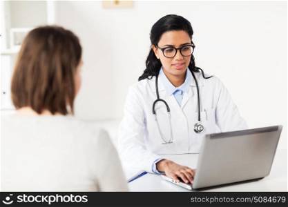 medicine, healthcare, technology and people concept - doctor with laptop computer and woman patient at hospital. doctor with laptop and woman patient at hospital. doctor with laptop and woman patient at hospital
