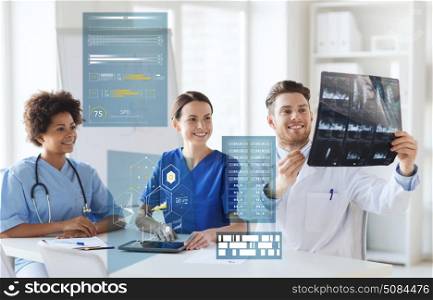 medicine, healthcare, technology and people concept - group of happy doctors discussing x-ray scan at hospital. group of happy doctors looking at x-ray image. group of happy doctors looking at x-ray image