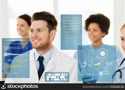 medicine, healthcare, technology and people concept - happy male doctor over group of medics meeting at hospital. happy doctor over group of medics at hospital. happy doctor over group of medics at hospital