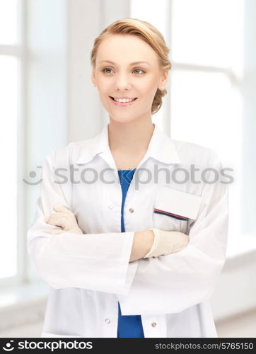 medicine, people, profession and healthcare concept - smiling young female doctor in white coat in hospital
